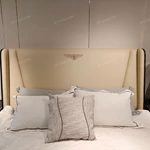 Cream Leather Upholstered Bed with Dark Natural Wood Veneer Trim, Embossed Brand Emblem & Copper-Accented Hardware